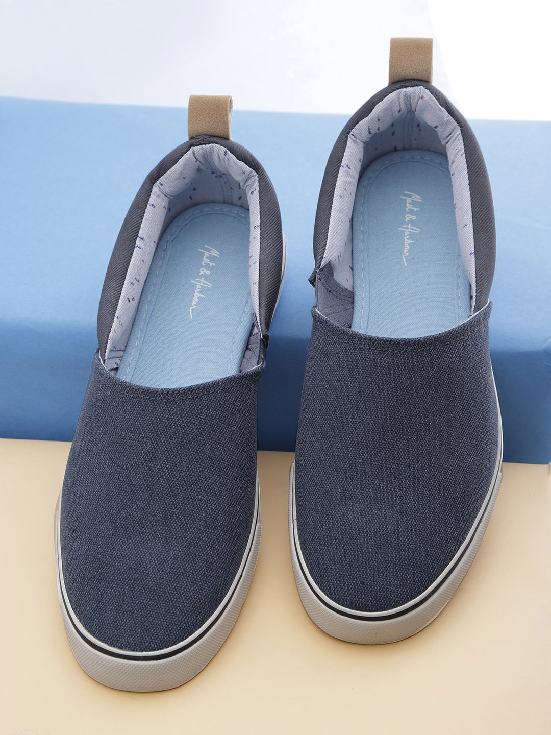 navy blue slip on sneakers