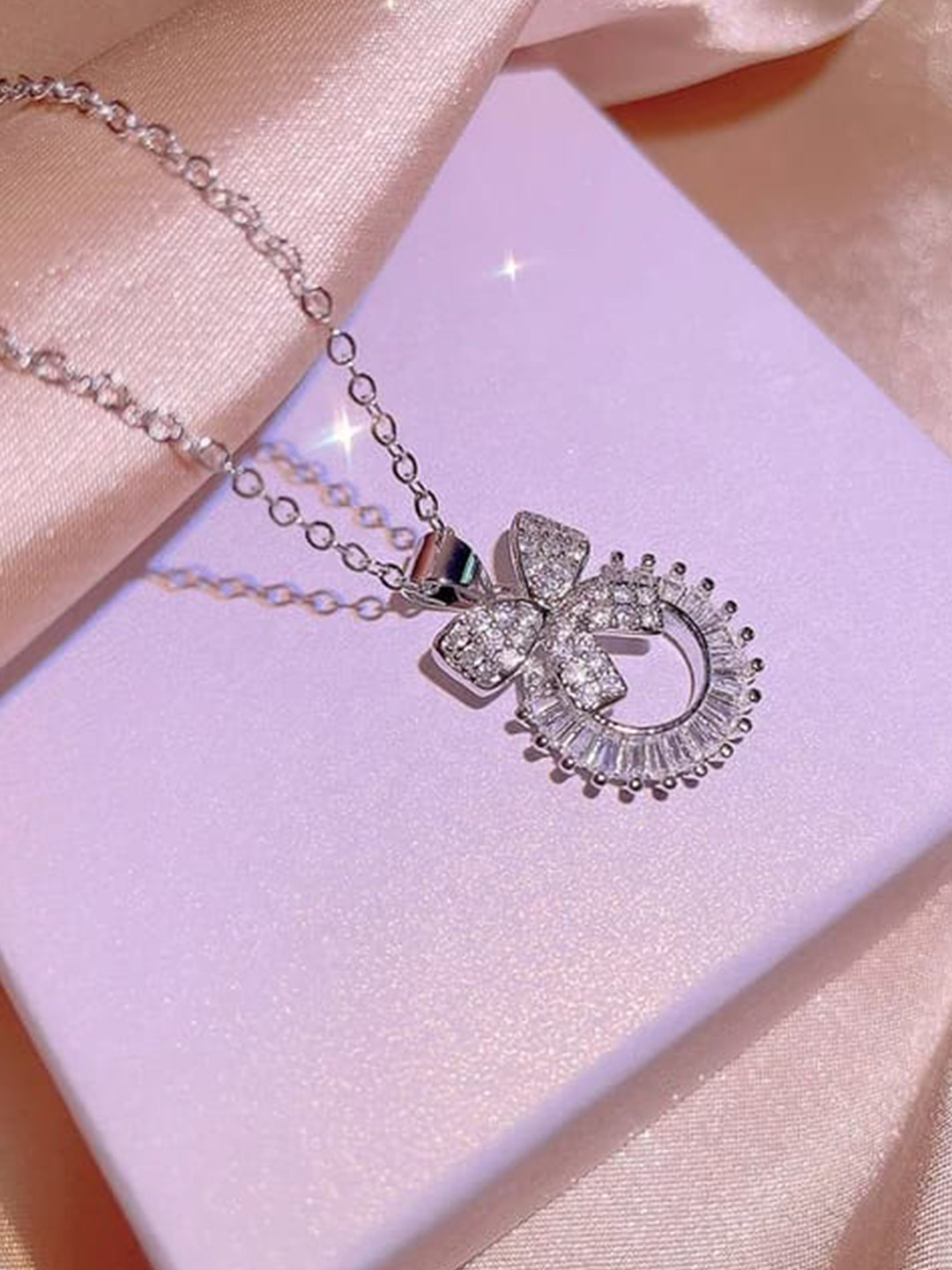 KRYSTALZ Silver-Plated Cubic Zirconia Studded Bow Round-Charm Pendant With Chain