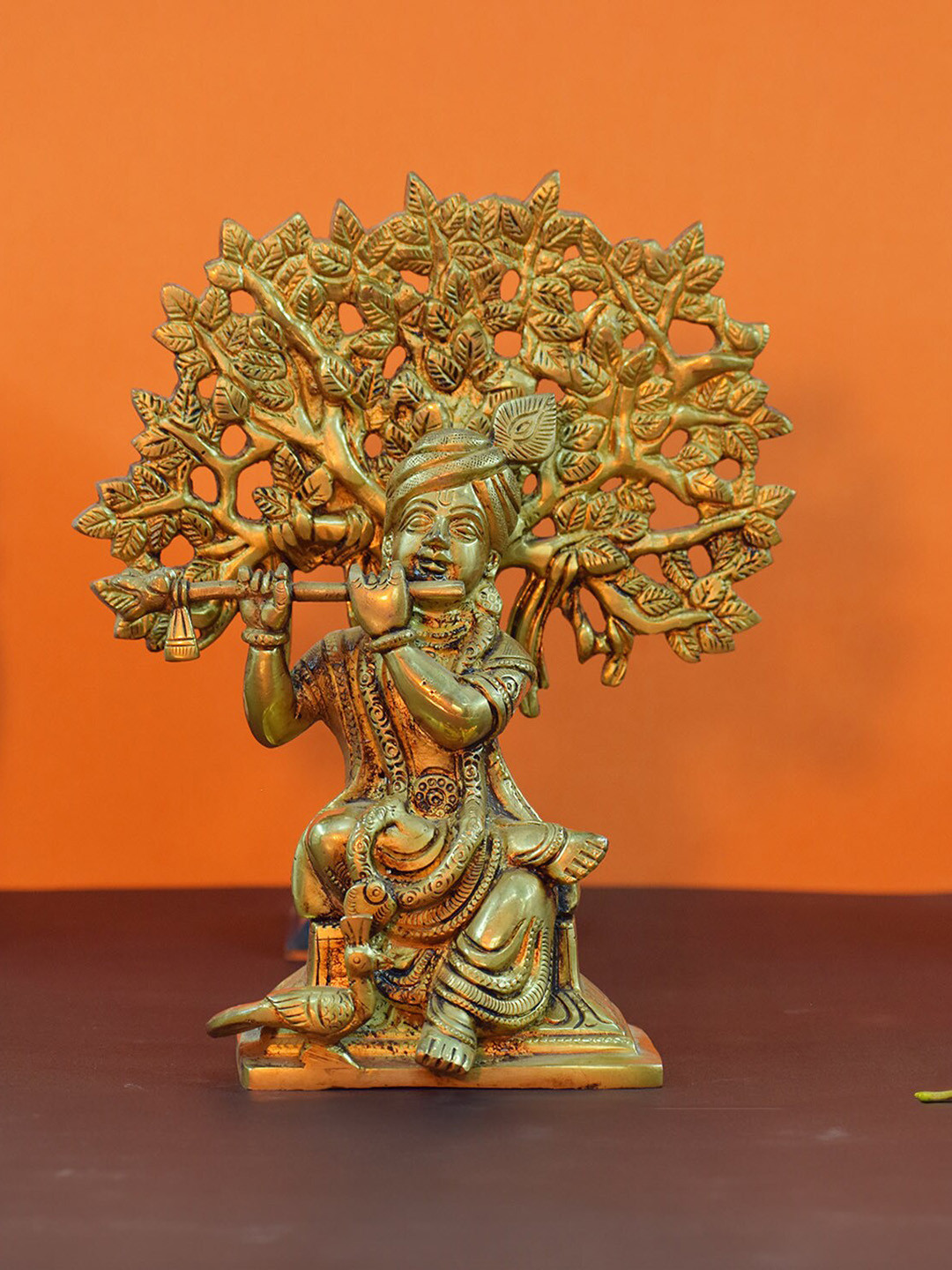 PujaNPujari Lord Krishna Sitting Under A Tree Gold Brass Metallic Prayer Room Small Showpiece - 7.9 Inches