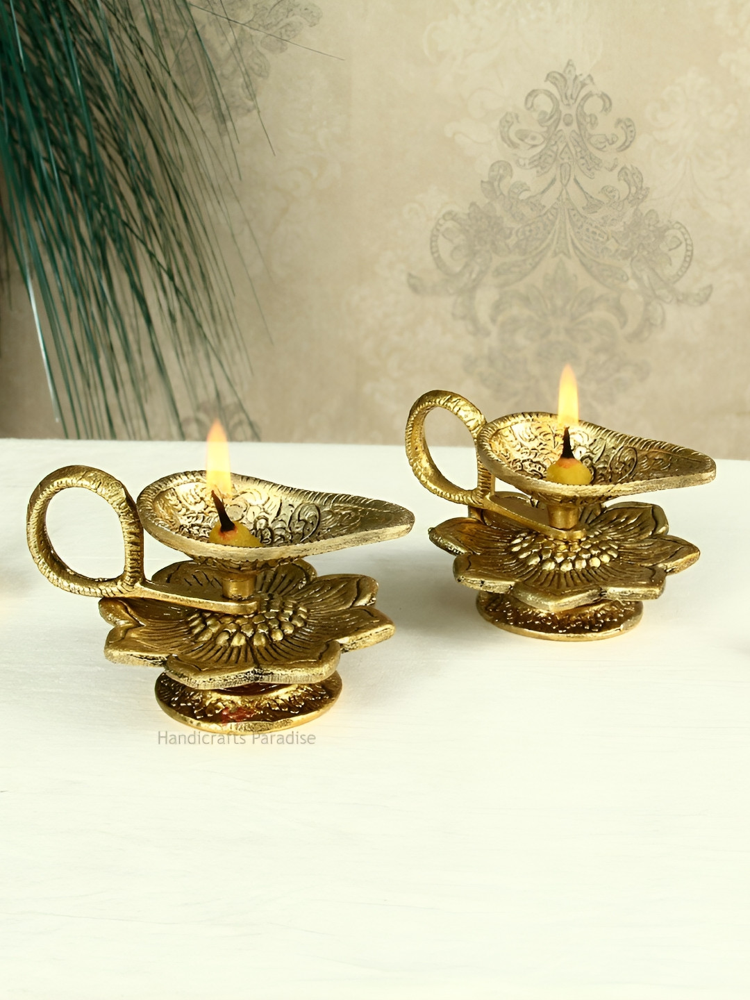 HANDICRAFTS PARADISE Gold Toned 2 Pcs Chirag & Flower Designed Antique Metal Pooja Diyas