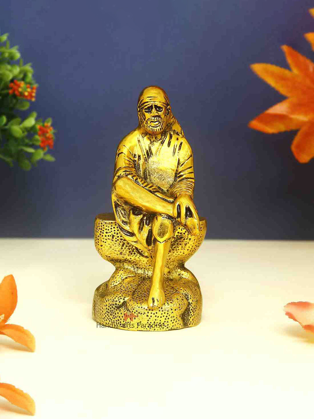 HANDICRAFTS PARADISE Sai Baba Seated on Rock Gold Metal Metallic Prayer Room Small Showpiece - 6.3 Inches