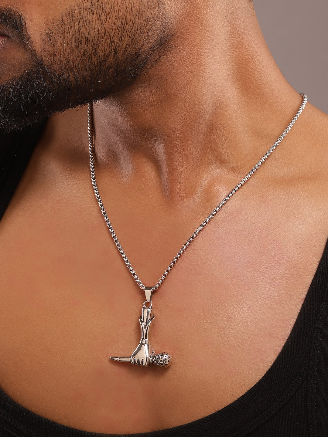 The Roadster Lifestyle Co Holding Mic Pendant With Chain