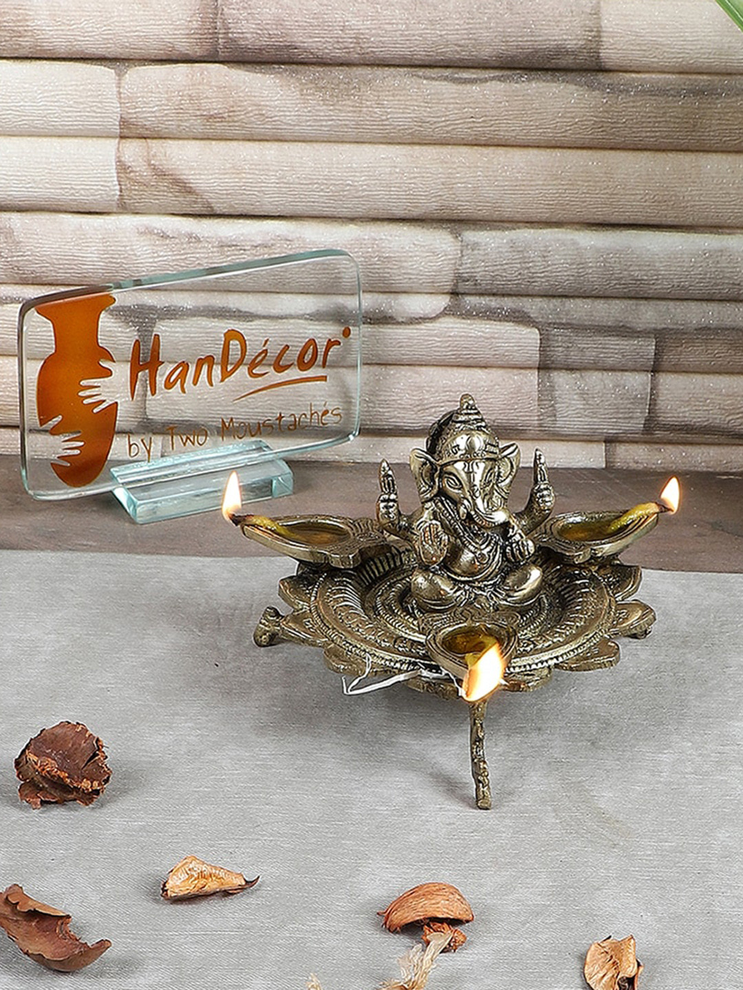 Two Moustaches Gold Toned Textured Ganesha On Lotus With Three Leaf Design Diya