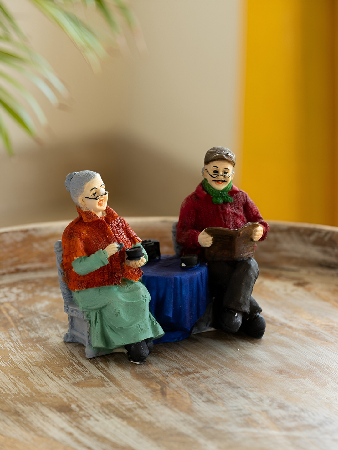 ExclusiveLane Italian Chit-Chatting Old Couple Blue Polyresin Natural Bedroom Medium Showpiece - 5.5 Inches