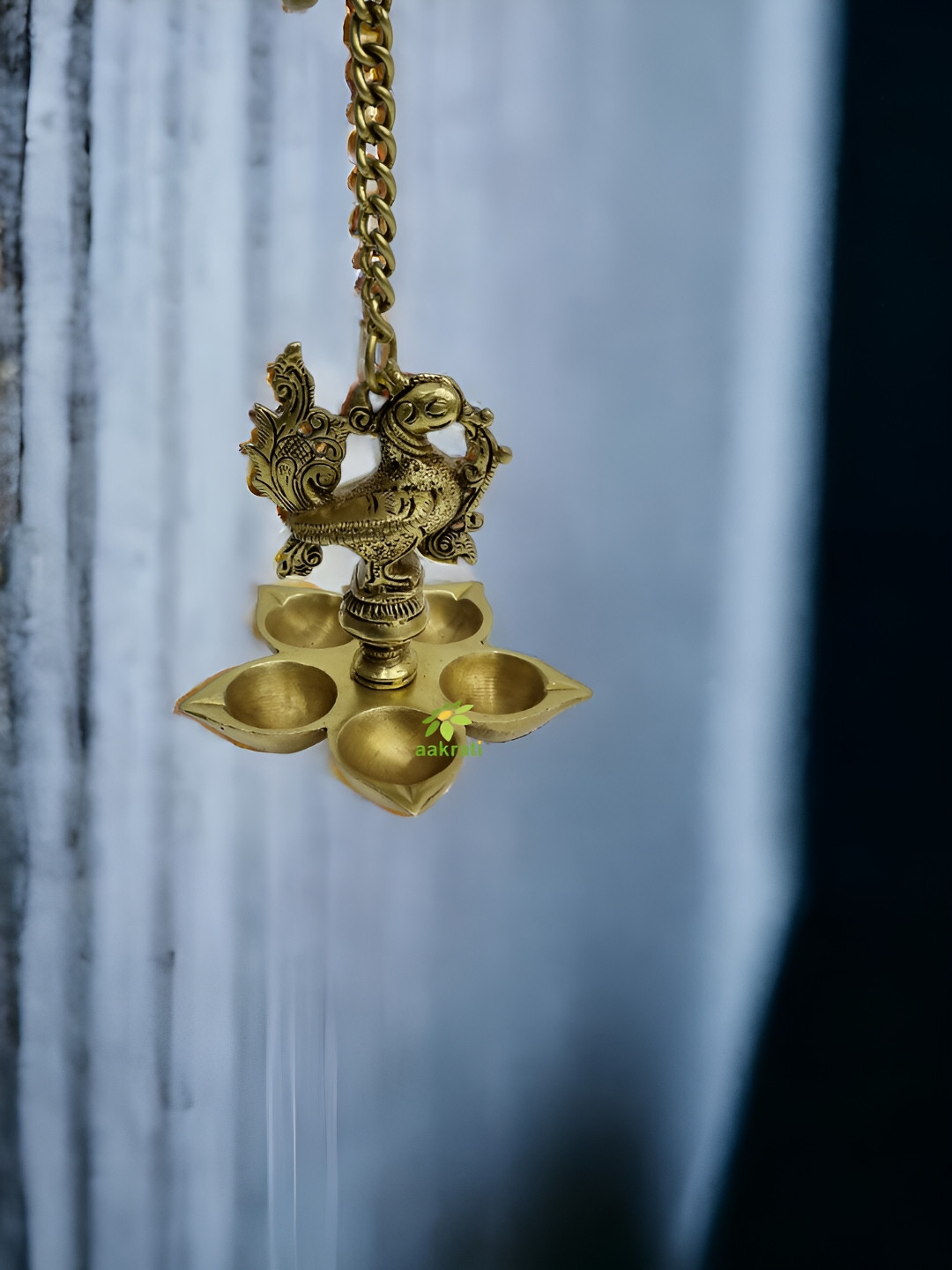 Aakrati Yellow Brass Peacock Hanging Diya