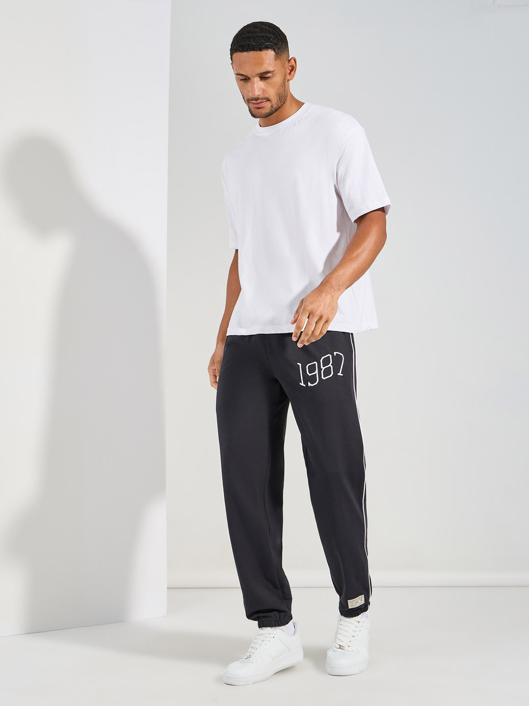 Styli Men Black Relaxed Fit Terry Joggers with Side cord and Embroidery Detail