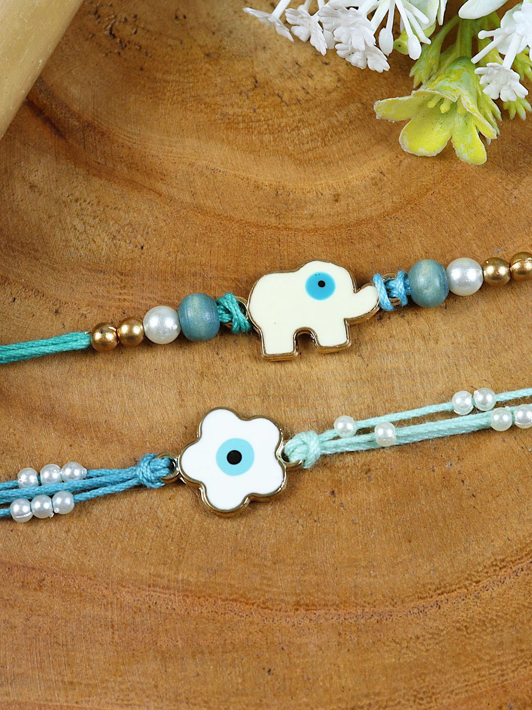 Asthetika Set of 2 Evil Eye Elephant and Flower Rakhis With Greeting Card & Roli Chawal