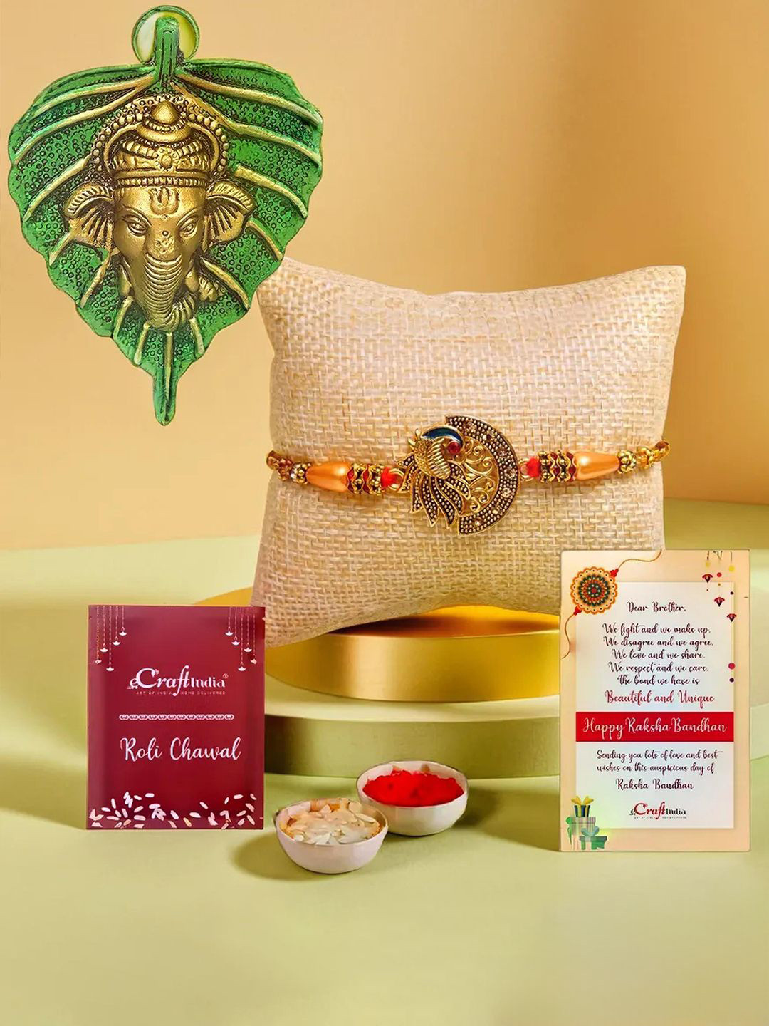 eCraftIndia Set Of 2 Peacock Designer Rakhi & Ganesha Face On Leaf Wall Hanging