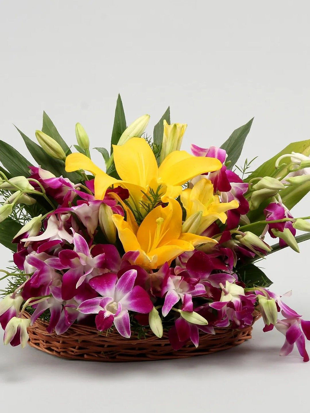 fnp Purple & Yellow 10 Pieces Orchids & Asiatic Lilies Fresh Flowers In Cane Basket