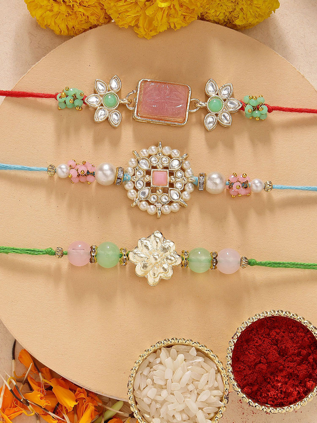 KARATCART Set of 3 Pink Carved Stone Floral Kundan Rakhis with Roli & Chawal