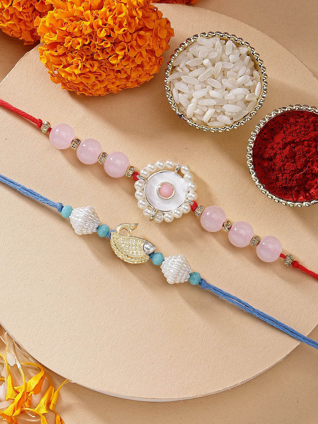 KARATCART Set of 2 Pink Beads Blue Fish Shape Kundan Rakhi with Roli & Chawal