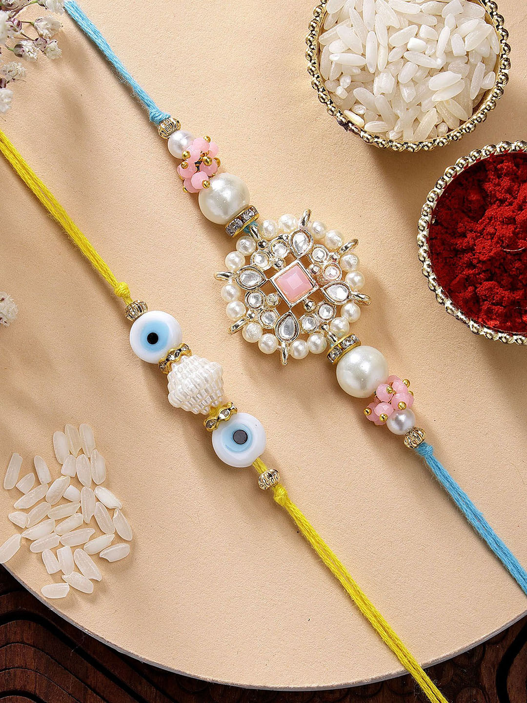 KARATCART Set of 2 Evil Eye & Pink Floral Kundan Rakhi with Roli & Chawal