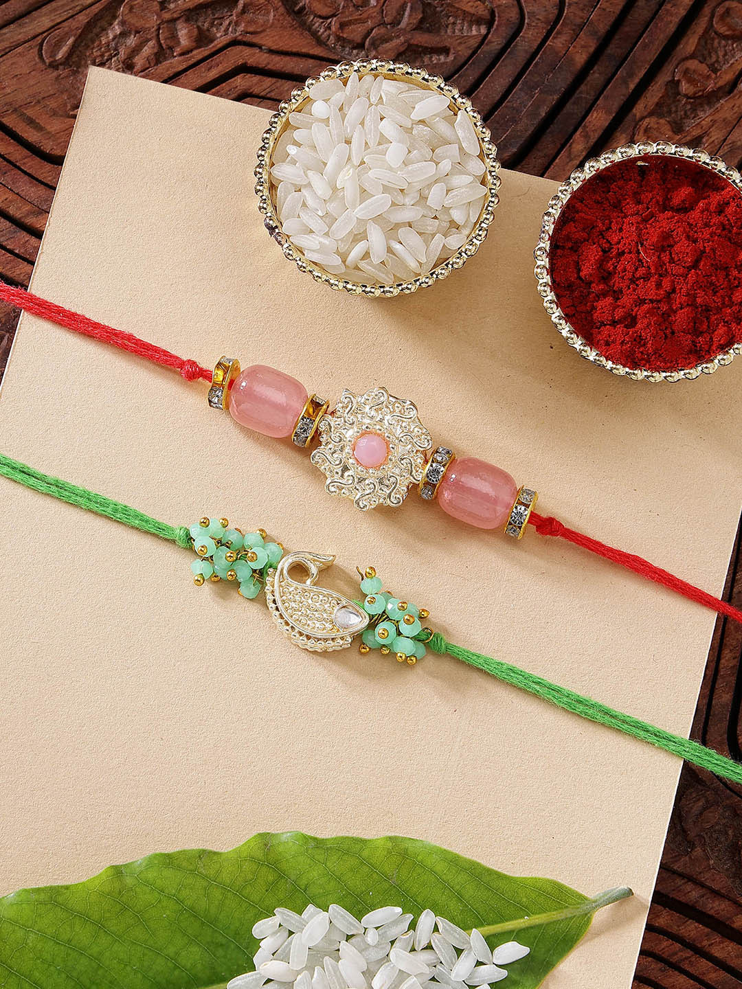 KARATCART Set of 2 Pink Stone & Green Fish Kundan Rakhi with Roli & Chawal