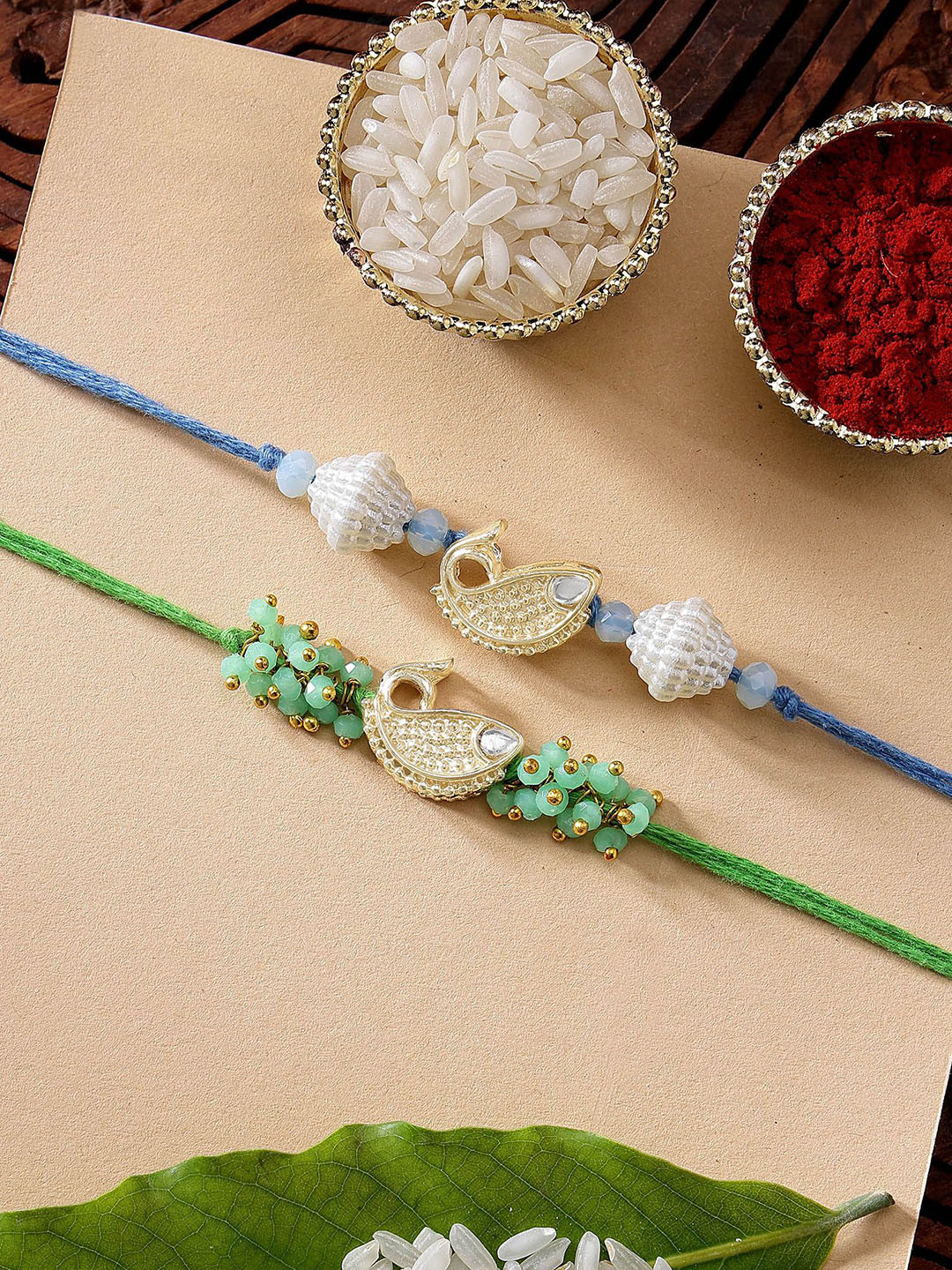 KARATCART Set of 2 Blue & Green Fish Kundan Rakhi with Roli & Chawal