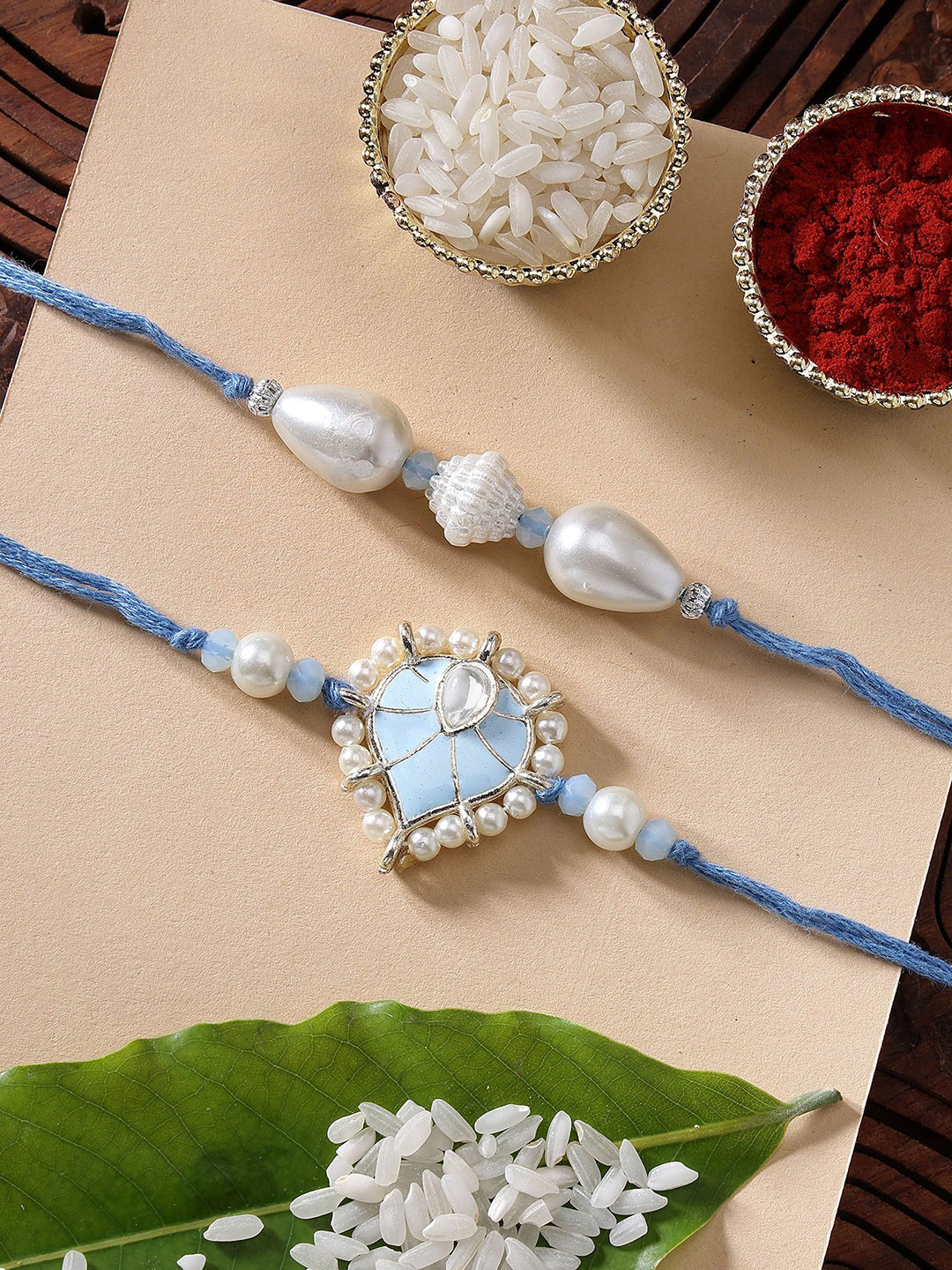 KARATCART Set of 2 Blue Heart Shape Kundan Rakhi with Roli & Chawal