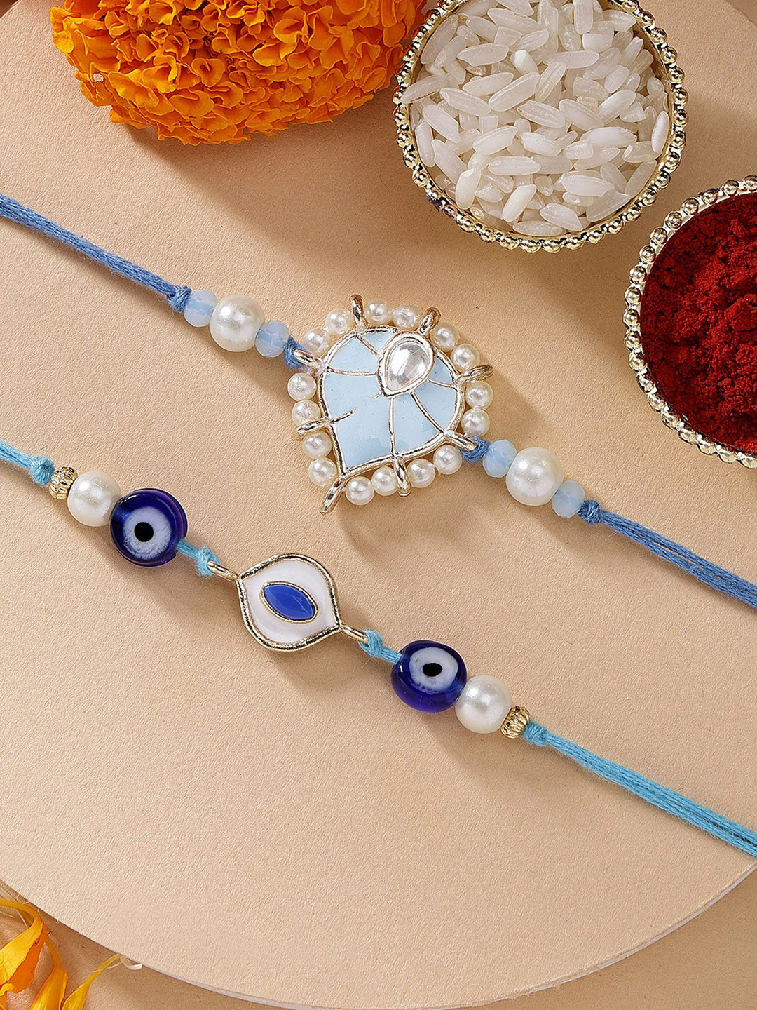 KARATCART Set of 2 Blue Evil Eye Heart Shape Kundan Rakhi with Roli & Chawal