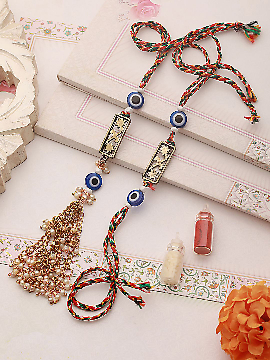 Jazz and Sizzle Evil Eye & Floral Motif Bhaiya Bhabhi Tasselled Rakhi with Roli & Chawal