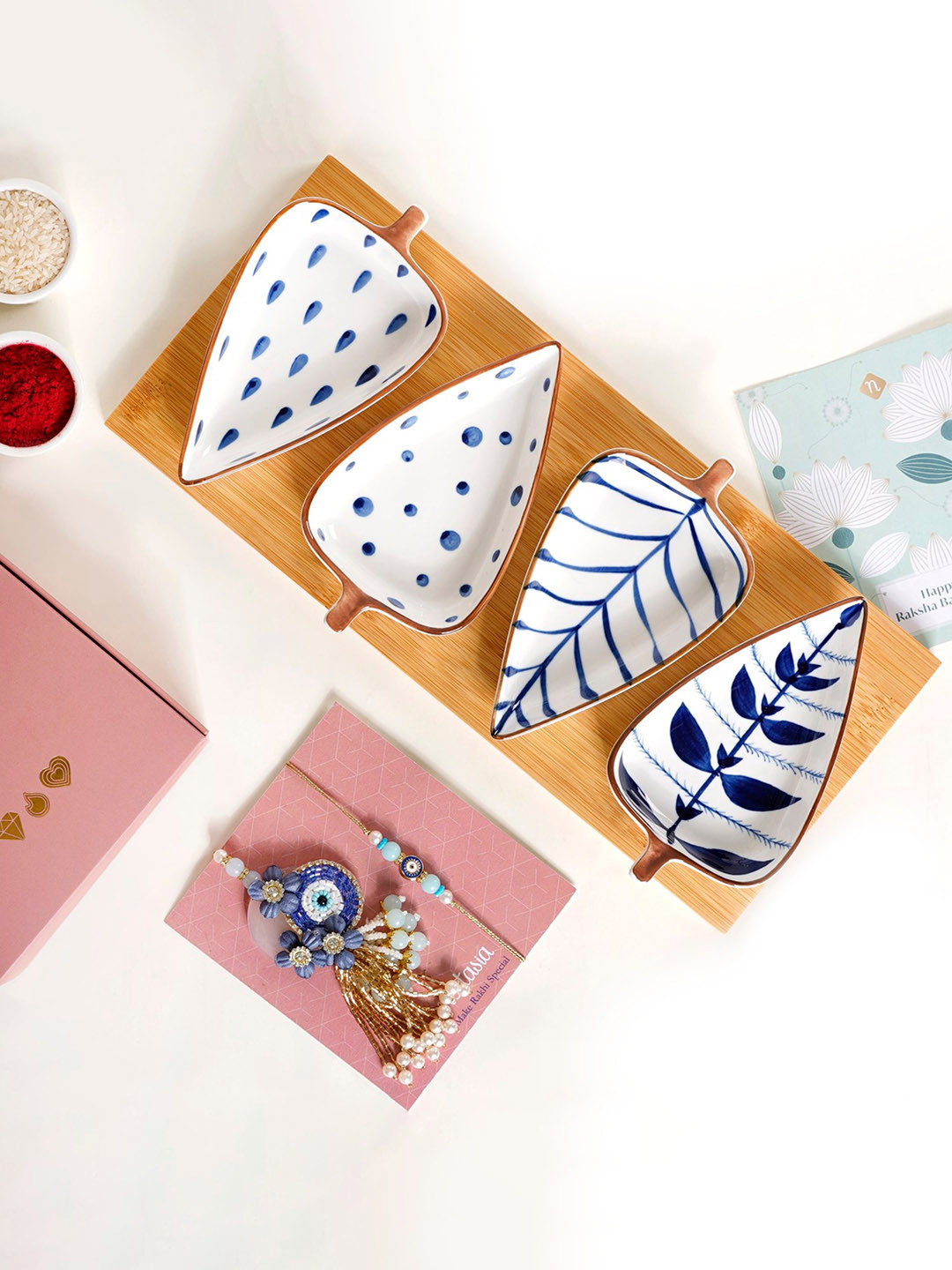 Nestasia Graceful Evil Eye Rakhi With 4 Pcs Platters On Charming Wooden Tray Gift Set