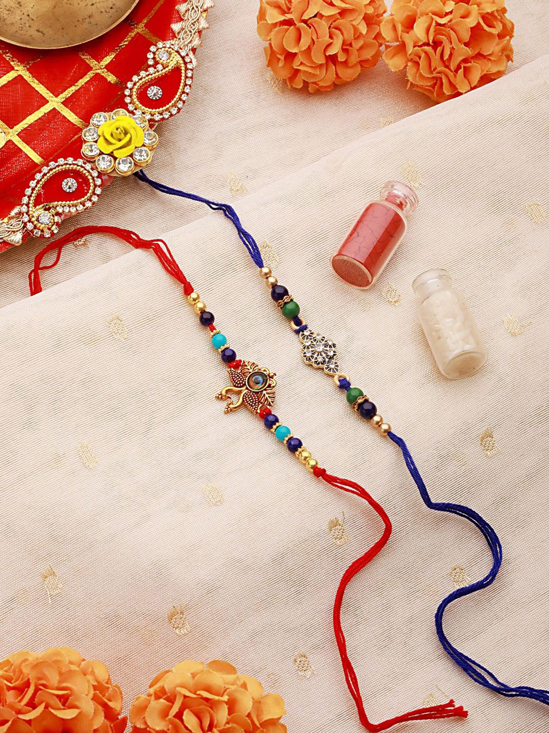 Jazz and Sizzle Set Of 2 Vibrant Evil Eye Peacock & Floral Shaped Rakhi with Roli & Chawal