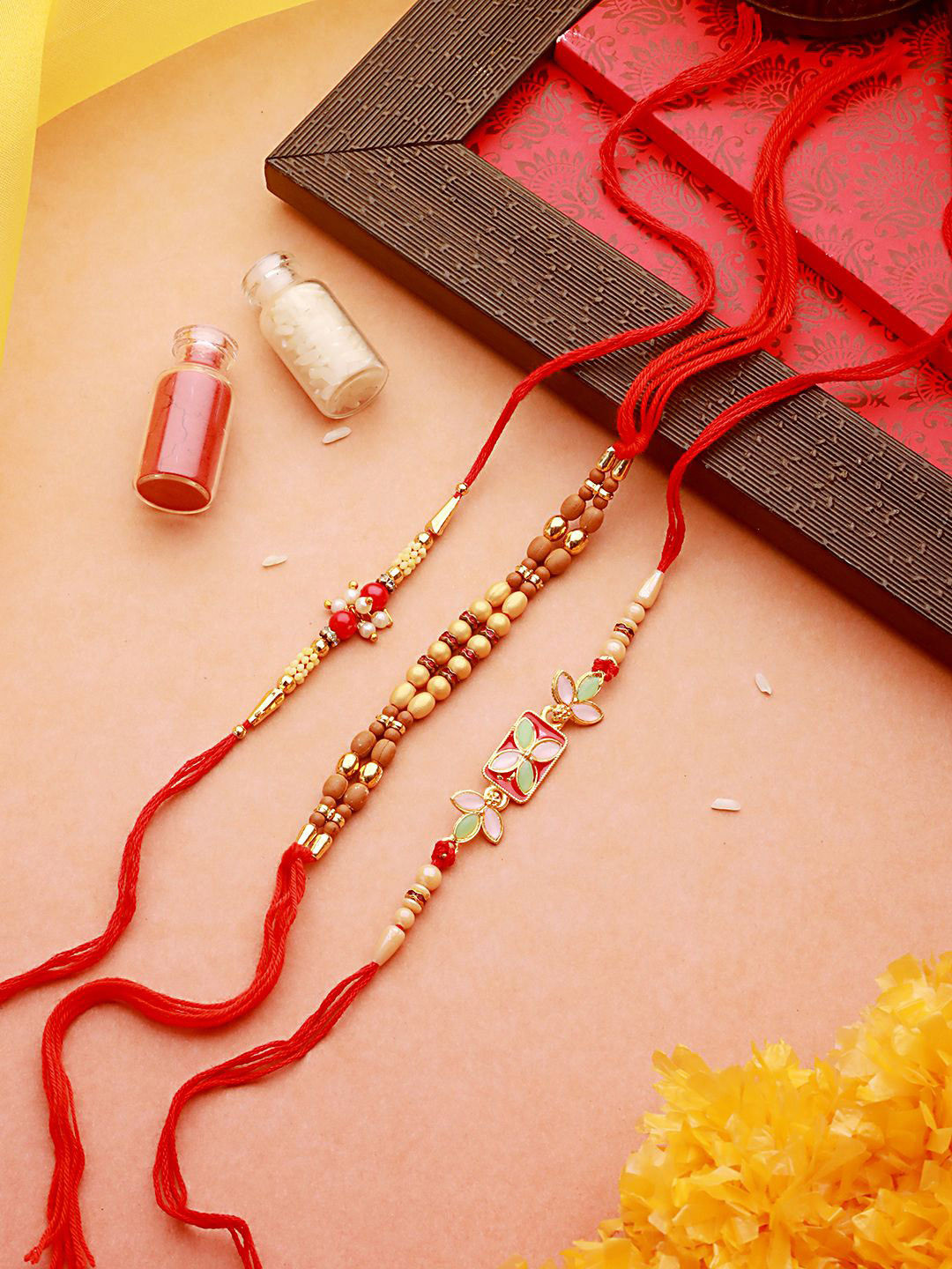 Jazz and Sizzle Set of 3 Faux Pearl & Meena Work Thread Rakhi With Roli Chawal