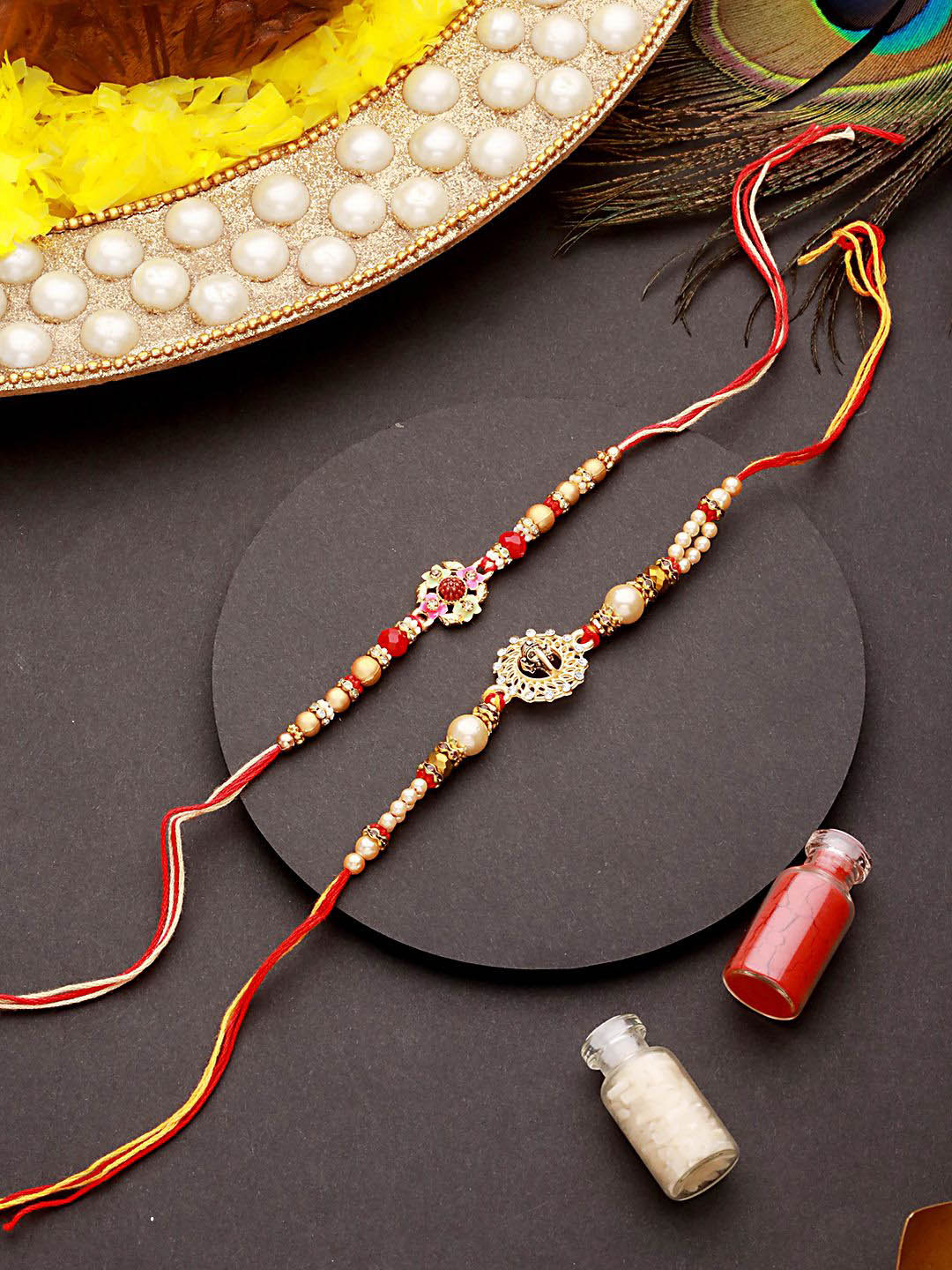 Jazz and Sizzle Set of 2 Om & Ganpati Rudraksh Rakhi with Roli Chawal