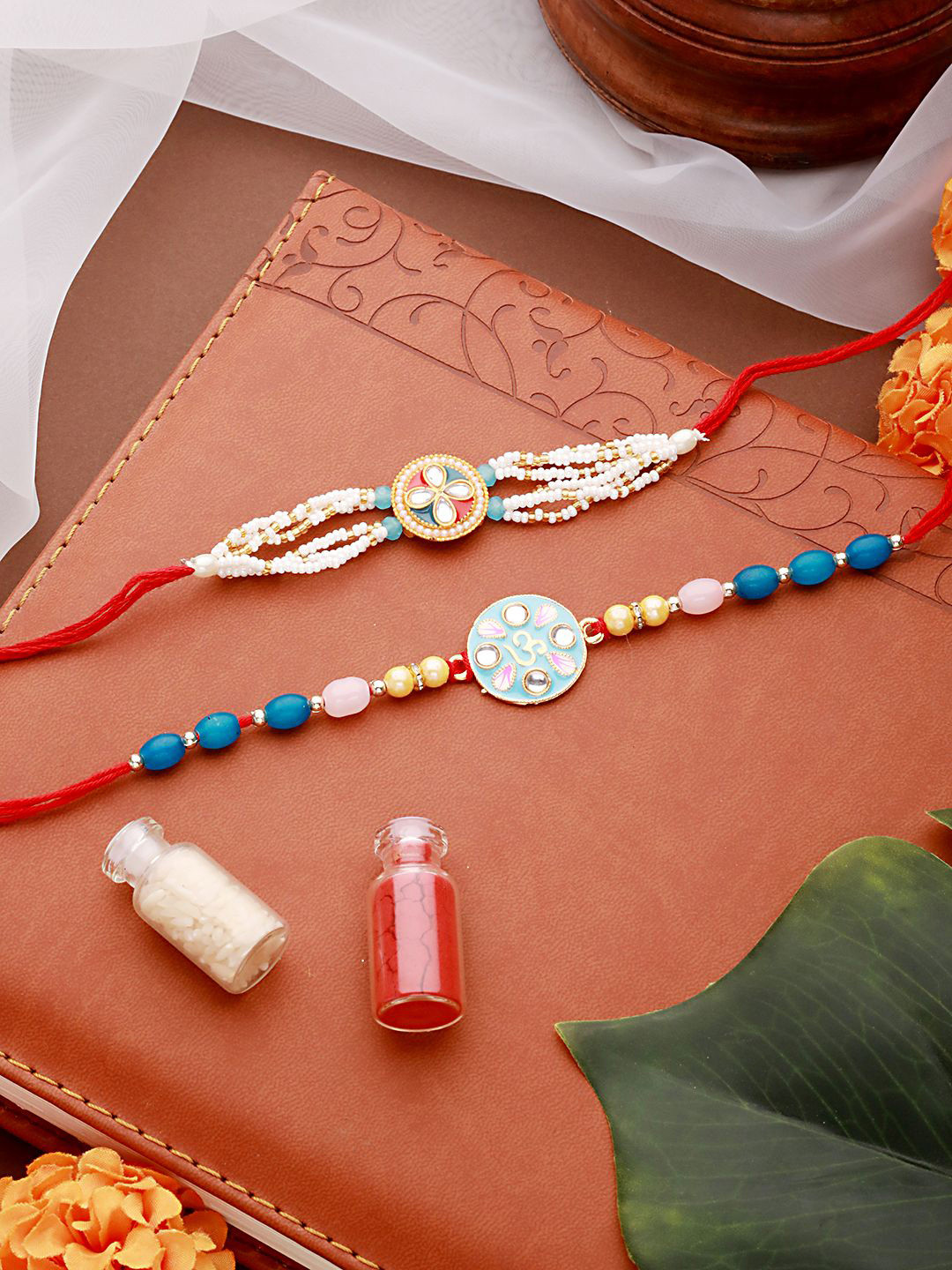 Jazz and Sizzle Set of 2 Meena Work & Pearl Beaded Thread Rakhi With Roli Chawal