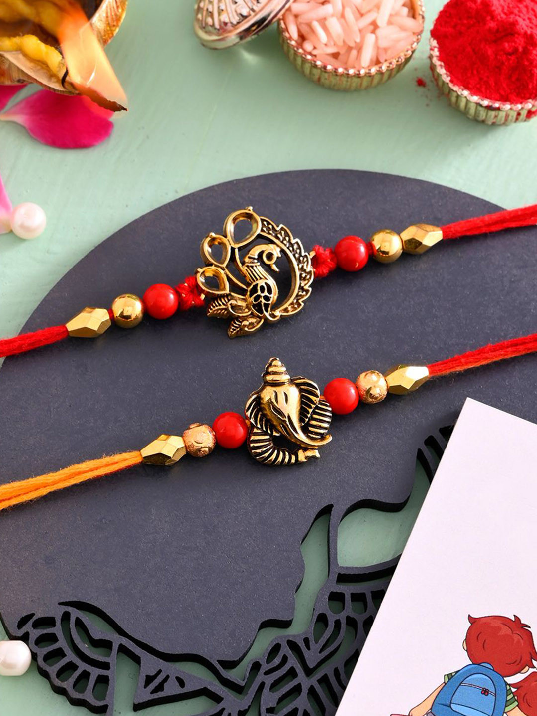 Ascension Set of 2 Peacock & Ganesh Beaded Thread Rakhis with Roli Chawal