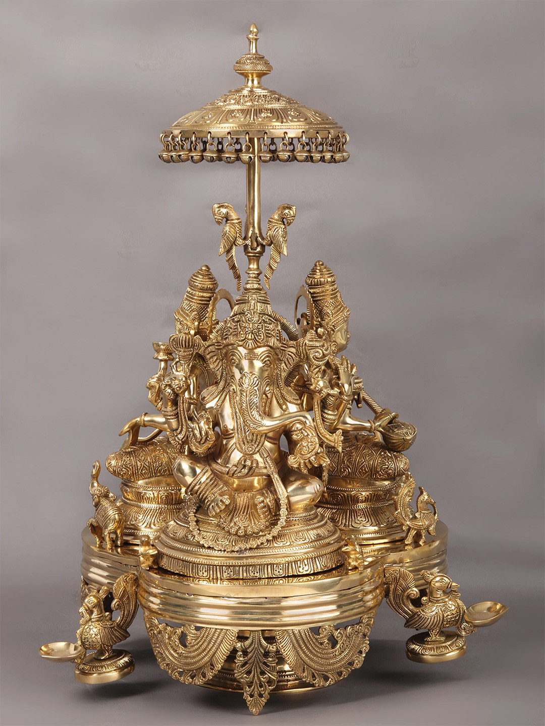 Exotic India Revolving Ganesha, Lakshmi and Saraswati Gold Brass Metallic Prayer Room Hand Made Extra Large Showpiece - 26 Inches