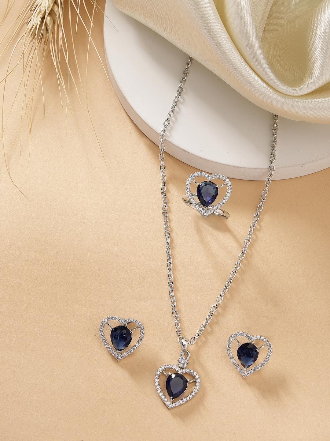 ZENEME Rhodium Plated Silver toned Heart Shaped Blue AD Pendant set with Earrings & Ring