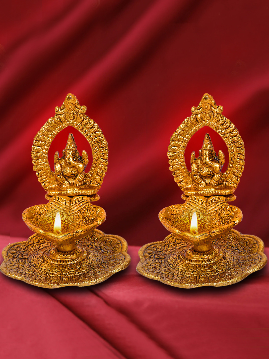 TIED RIBBONS Gold Toned 2 Pieces Textured Metal  Lord Ganesha With Bati Diya