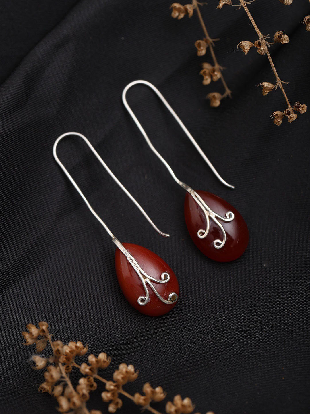 Exotic India Sterling Silver Long Hook Earrings with Almond Shaped Ruby