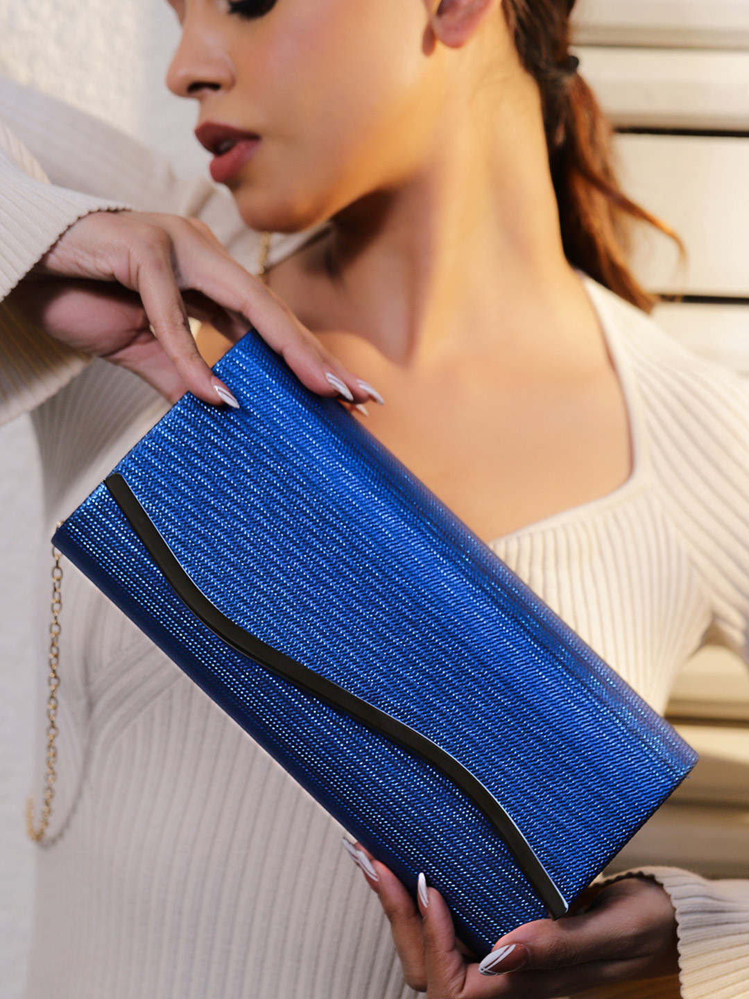 Rubans Sapphire Blue Glossy Textured Clutch with Silver Tone Wavy Accent & Chain