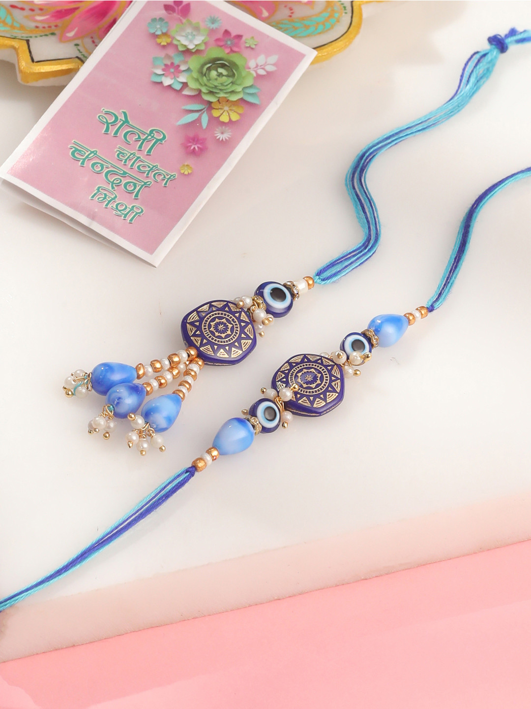 NVR Evil Eye Set of 2 Blue Artificial Beads Bhaiya Bhabhi Rakhi with Roli Chawal