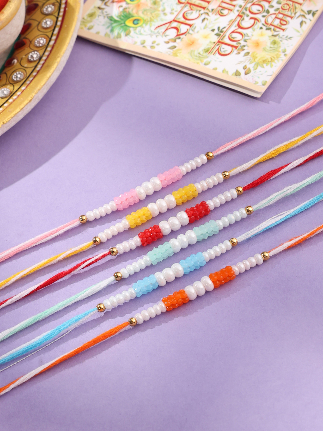 NVR Unisex Set of 6 Multicolor Pearls Thread Rakhi with Roli Chawal, Rakshabandhan Combo