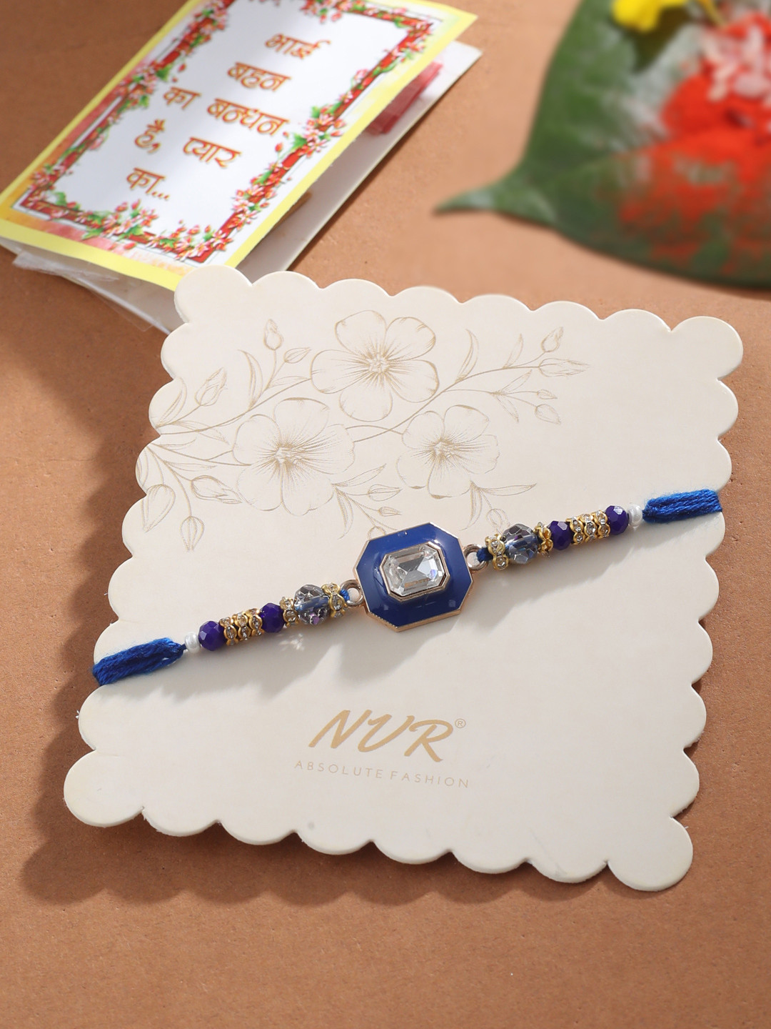 NVR Unisex Blue Artificial Stones Handmade Thread Rakhi with Roli Chawal