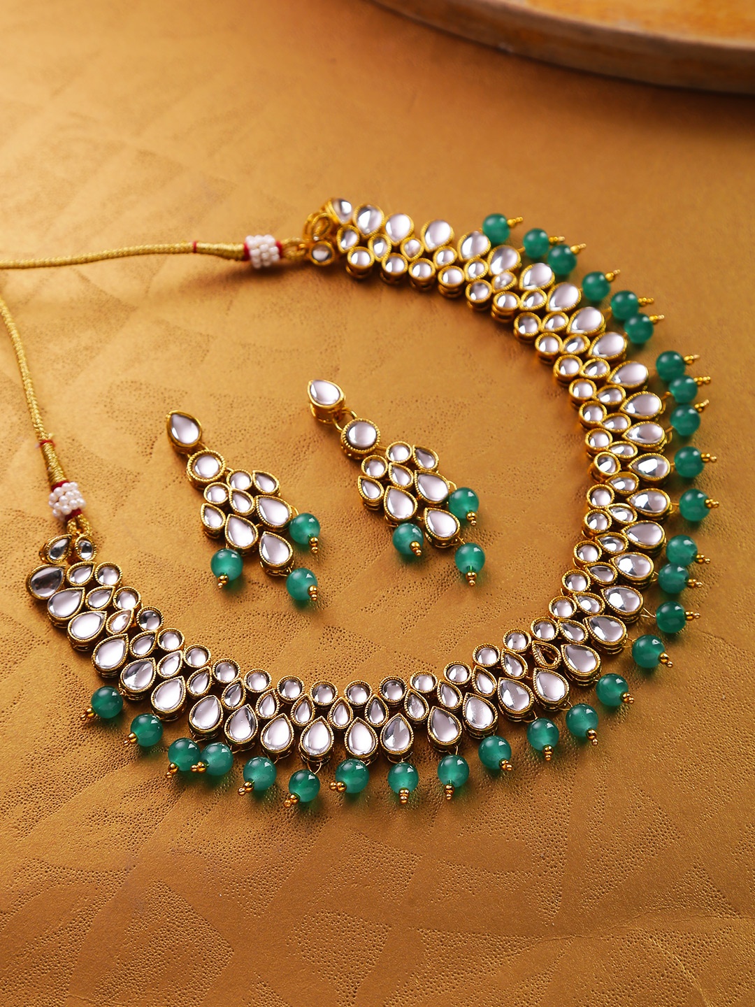 

Jewels Galaxy Women Green Gold-Plated Stone-Studded Beaded Jewellery Set