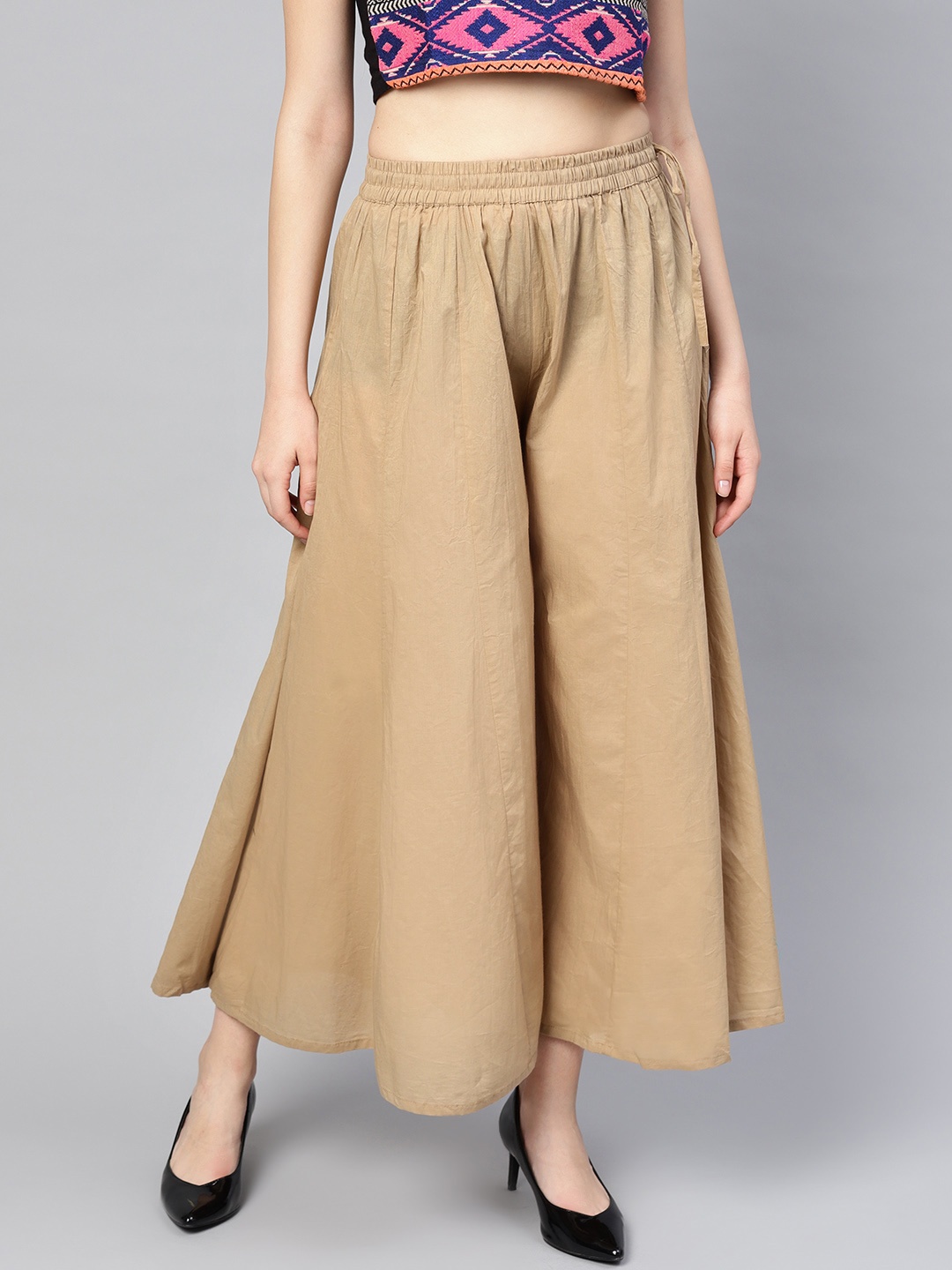 

Varanga Women Beige Solid Wide Leg Palazzos