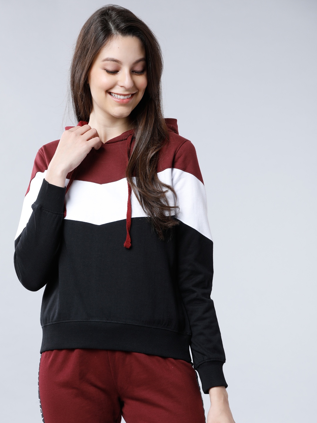 

Tokyo Talkies Women Maroon & White Colourblocked Hooded Sweatshirt