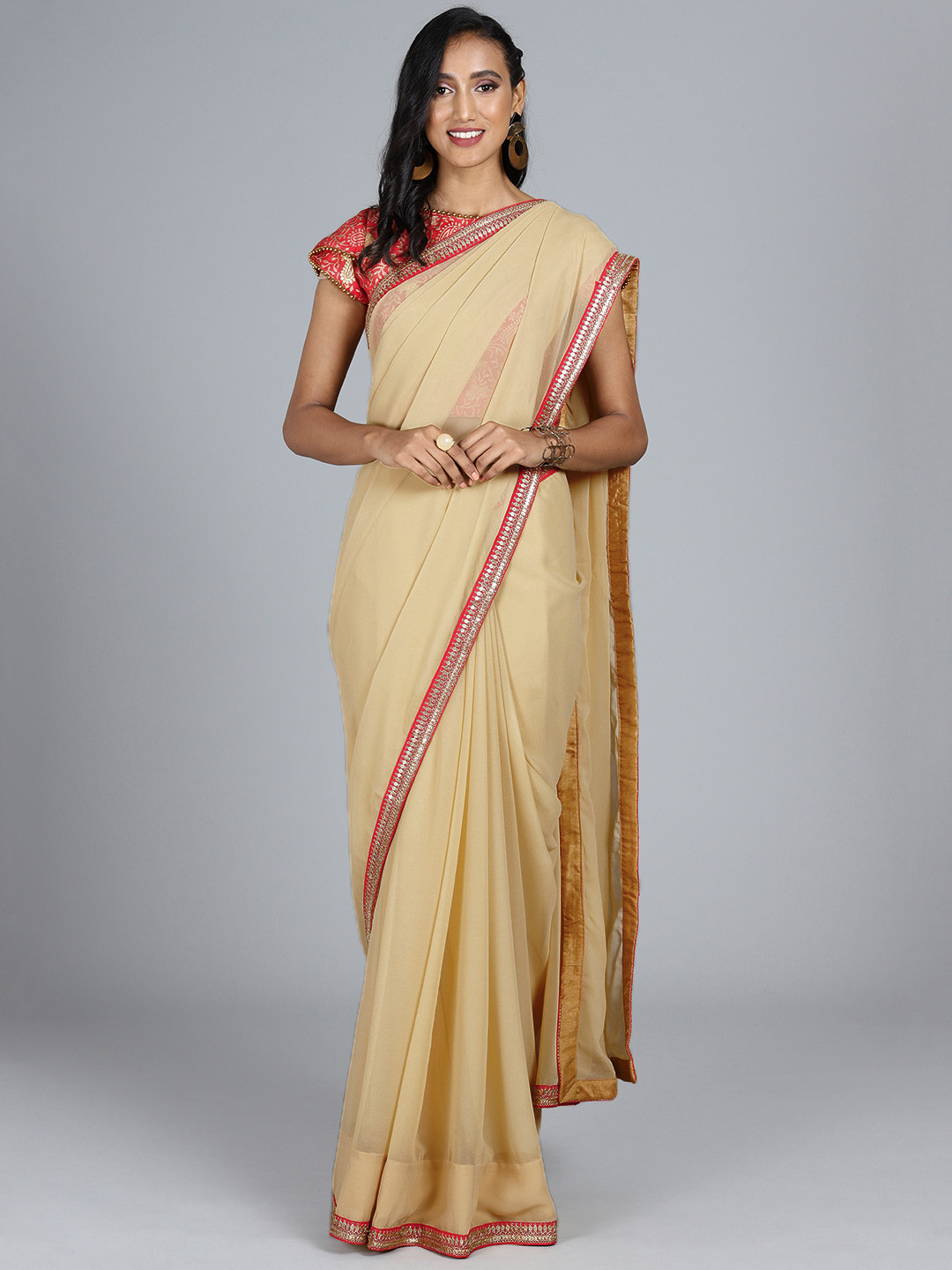

Ethnovog Beige Red Poly Georgette Solid Saree