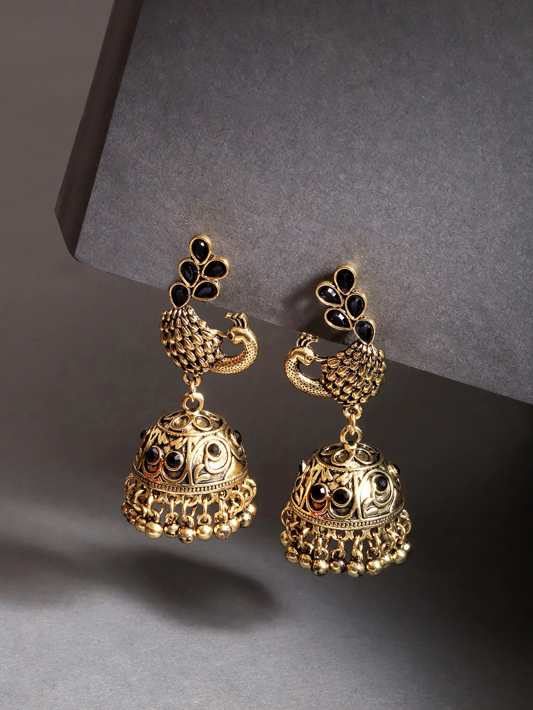 

Jewels Galaxy Black Antique Gold-Plated Stone-Studded Textured Dome Shaped Jhumkas