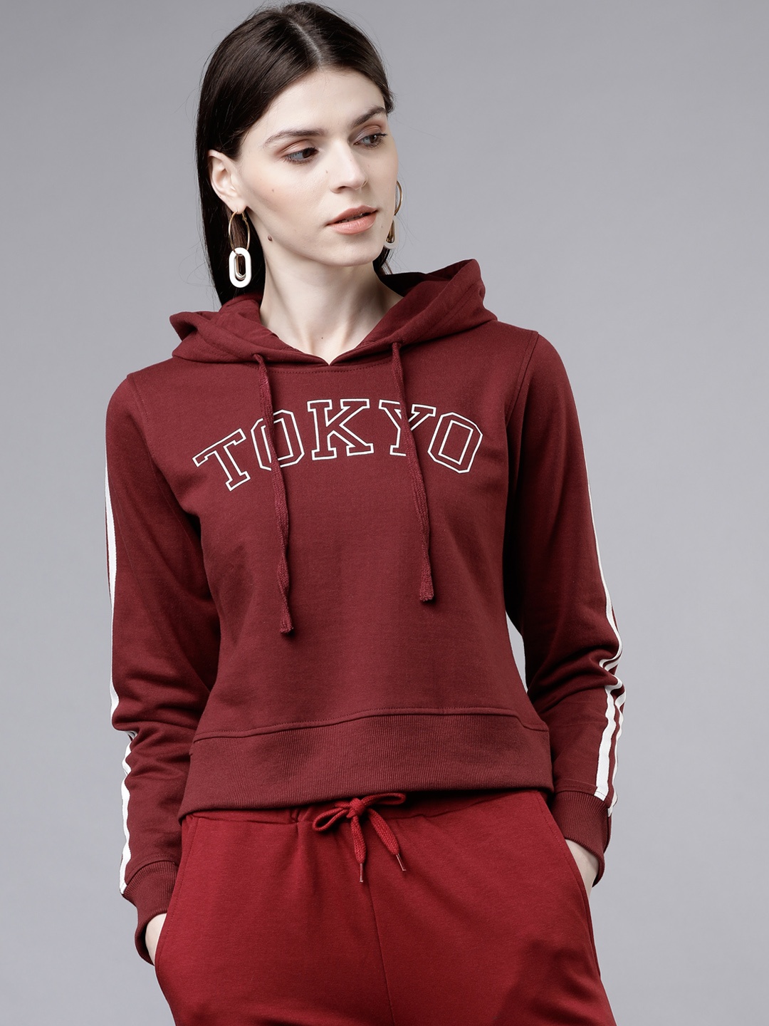 

Tokyo Talkies Women Maroon & White Solid Hooded Sweatshirt