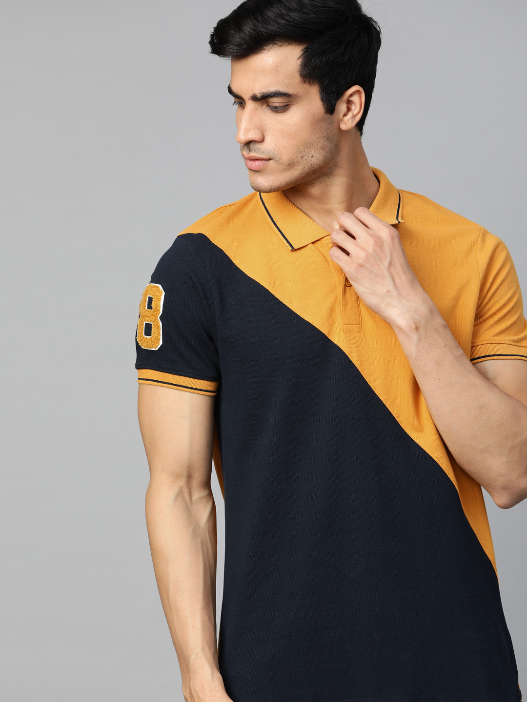 

The Roadster Lifestyle Co Men Navy Blue & Mustard Yelllow Colourblocked Polo Collar T-shirt