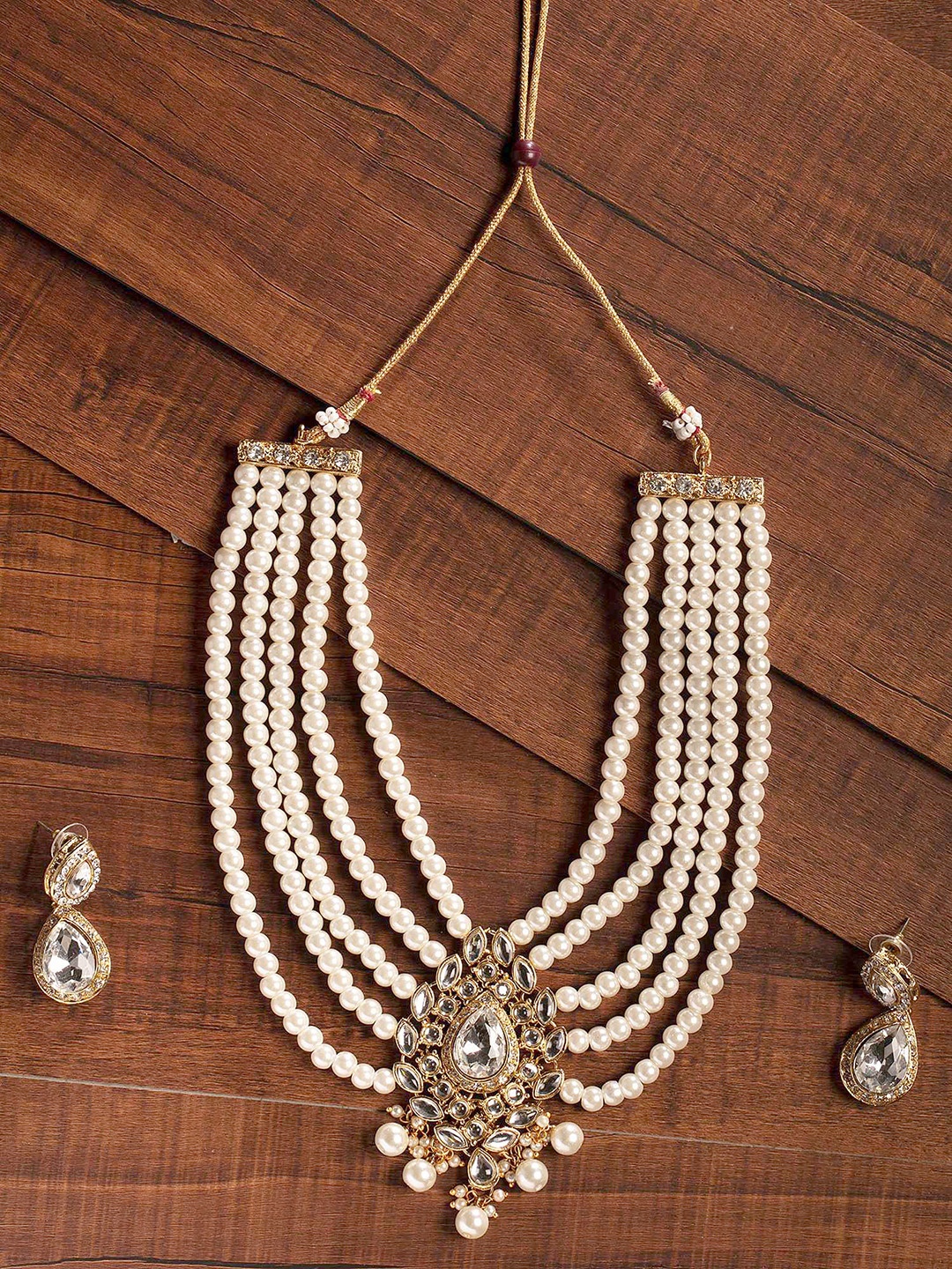 

Zaveri Pearls Gold-Toned & White Kundan & Pearl Studded Multi-Strand Jewellery Set