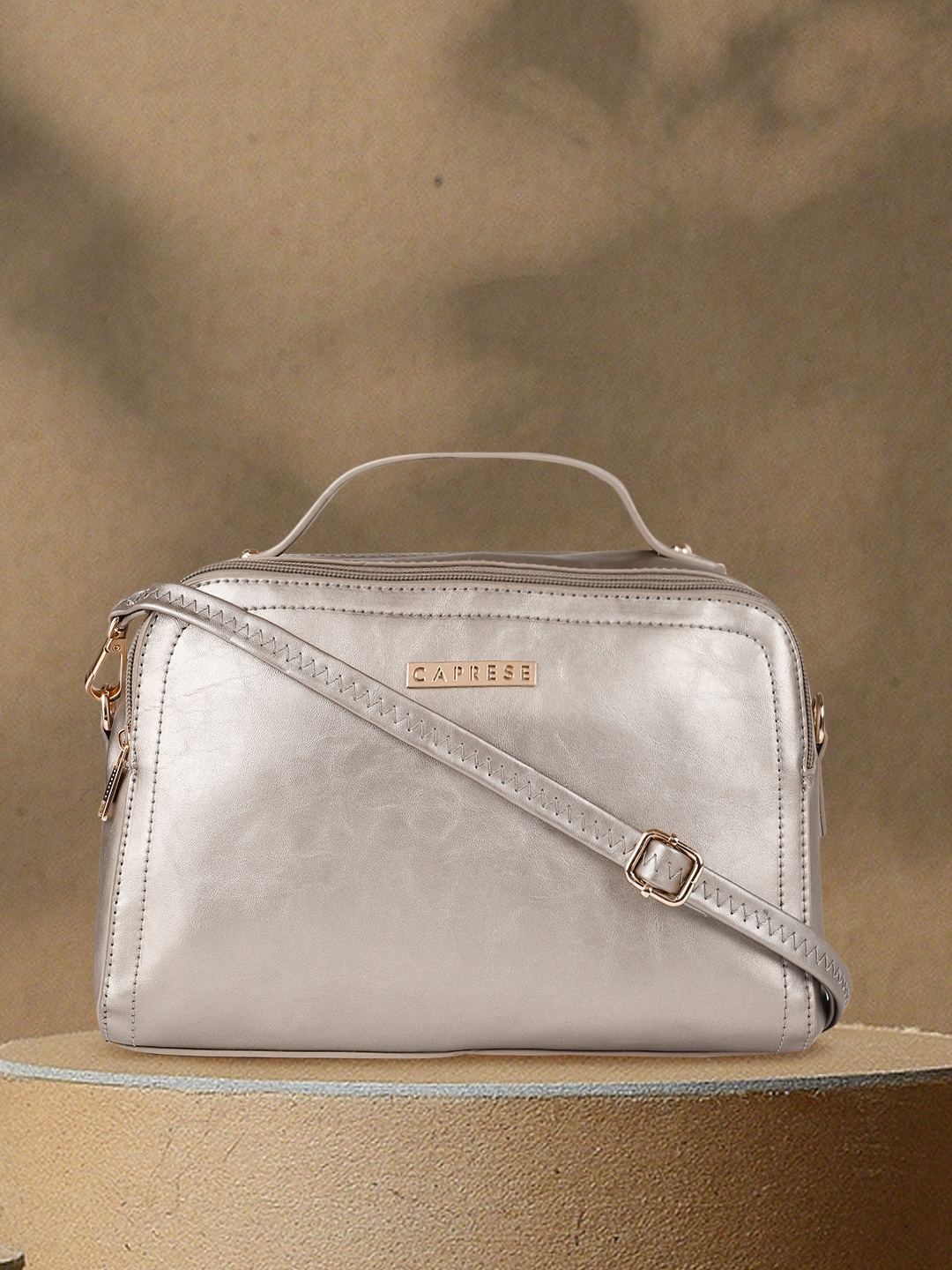 

Caprese Metallic Solid Sling Bag