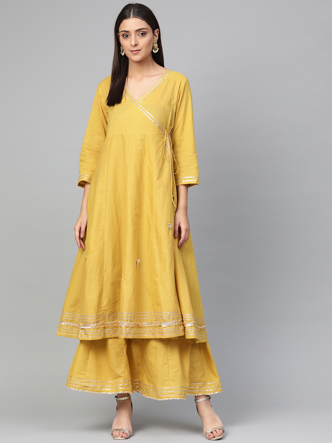 

Bhama Couture Women Mustard Yellow Solid Gotta Patti Work Angrakha Kurta with Skirt