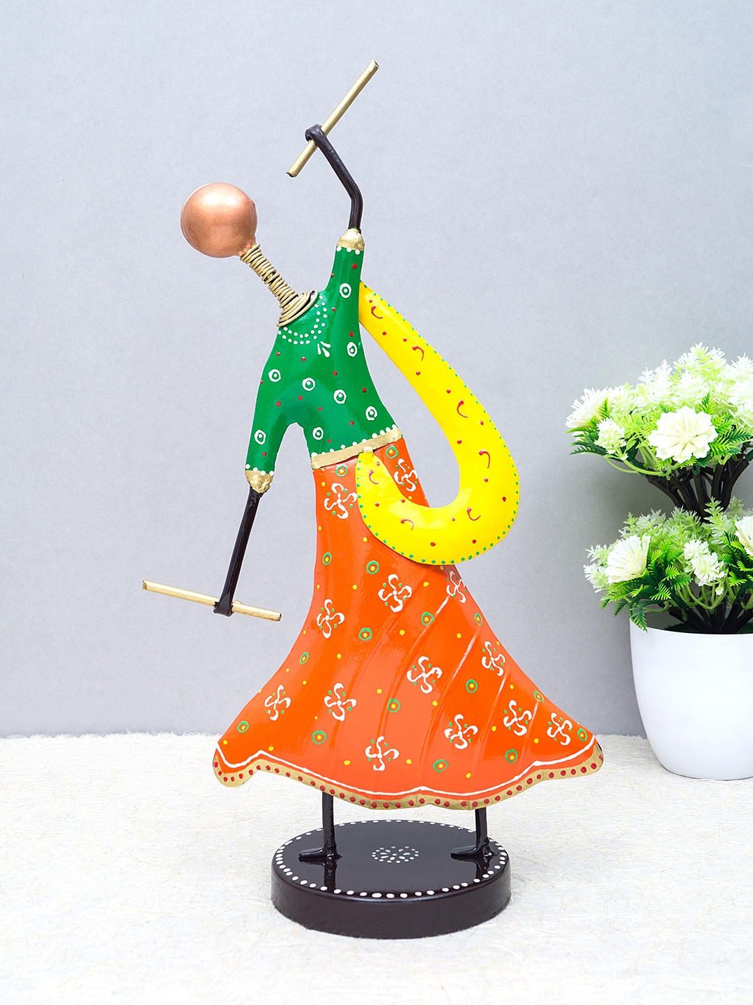 

Golden Peacock Orange & Green Handcrafted Metal Garba Playing Lady Showpiece