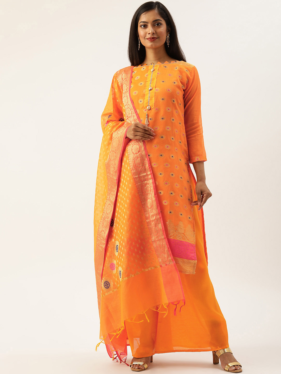 

Rajnandini Orange & Golden Silk Blend Unstitched Dress Material