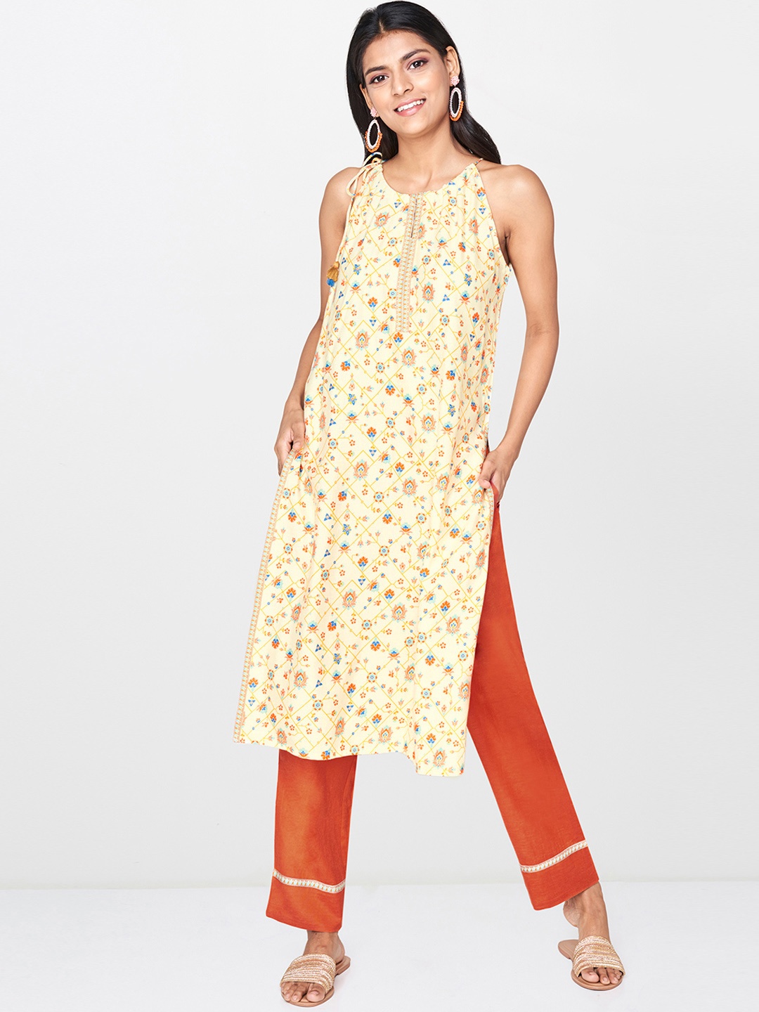 

Global Desi Women Cream-Coloured & Orange Printed Kurta with Trousers