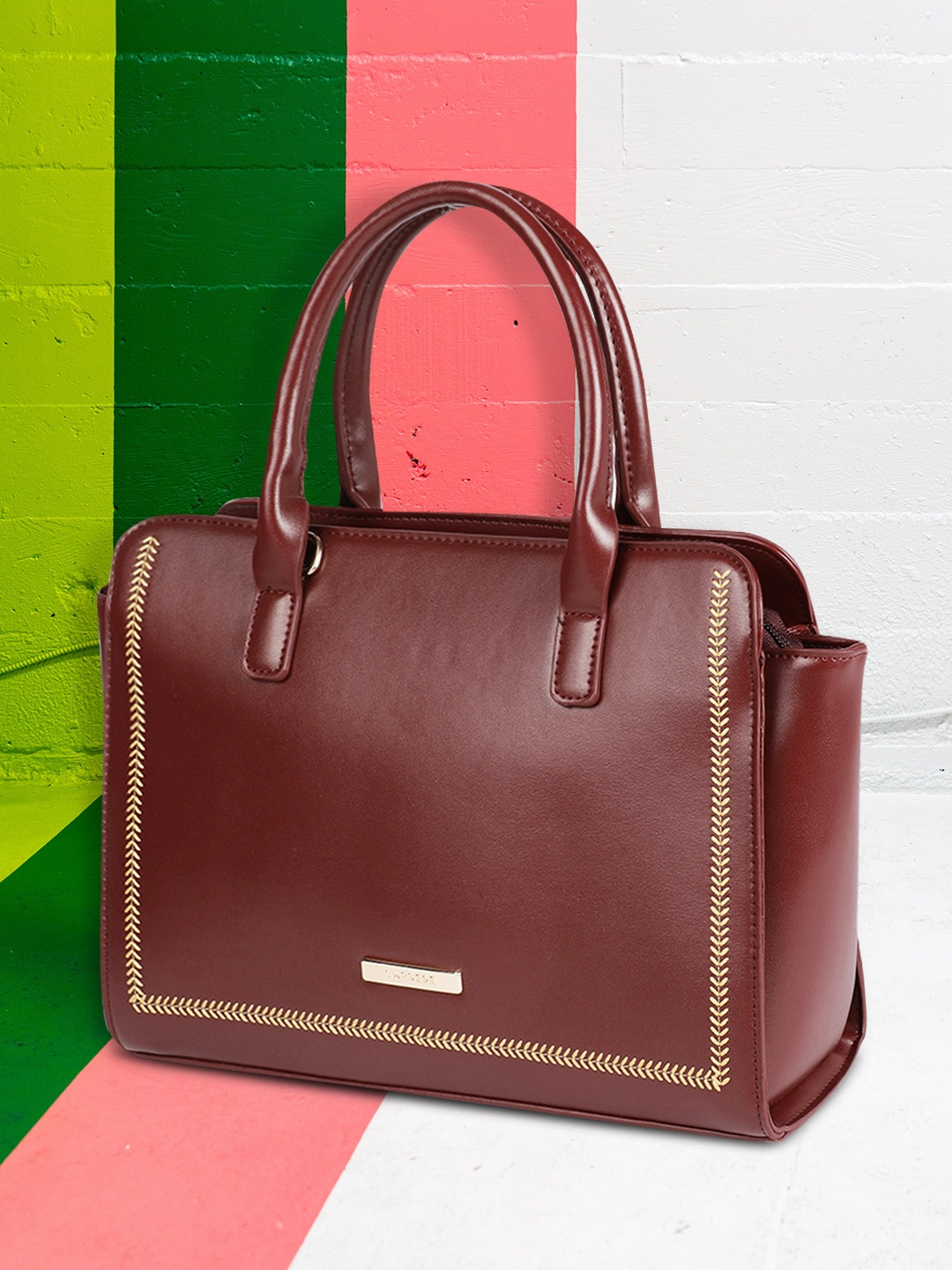 

Caprese Maroon Solid Handheld Bag