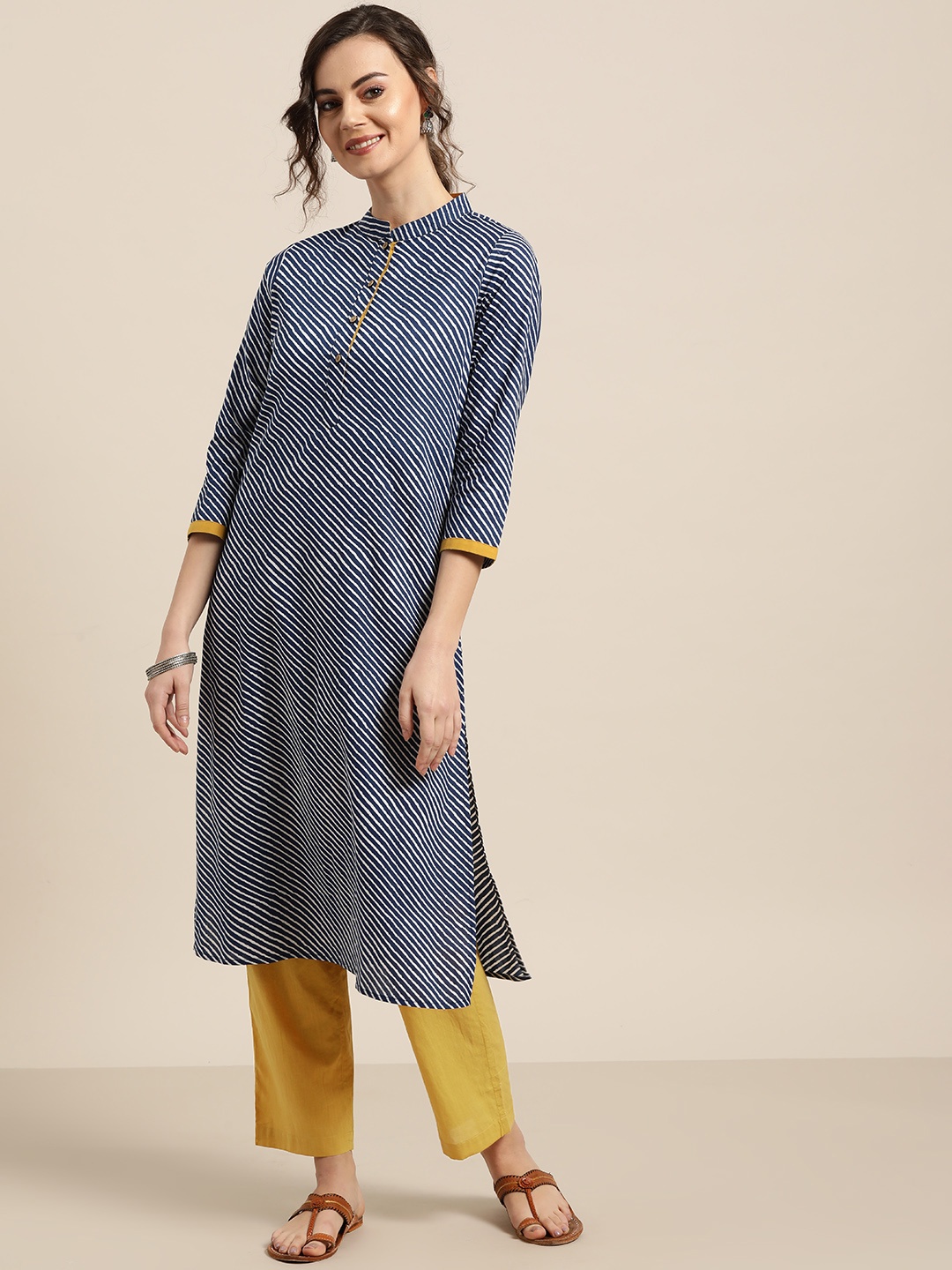 

Shae by SASSAFRAS Women Navy Blue & Mustard Yellow Striped Kurta with Trousers